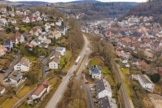 Aerial view of a village with railroad surrounded by hills and autumn trees, historic event, first