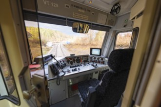 Driver's cab of a train with a view of the rails, technical instruments and control elements