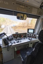 View from the train driver's cab on rails, with complex control panel and technology in the