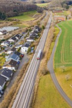 Station on a bend, surrounded by trees and fields near a settlement, historic event, first test run