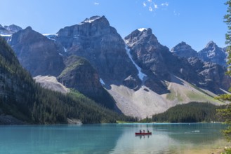 Breathtaking turquoise waters of moraine lake reflecting majestic mountains and glaciers in banff