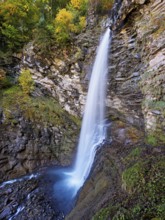 Diesbach waterfall in autumn-colored surroundings, Linthal, Klausenpass, Canton of Glarus,