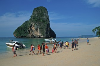Rocks in the sea, boats and people on Pranang Cave beach, two years in front of the tsunami, Krabi,