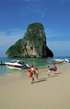 Rocks in the sea, boats and people on Pranang Cave beach, two years in front of the tsunami, Krabi,