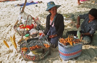 Woman and daughter with food stash on Pranang Cave beach, two years in front of the tsunami, Krabi,