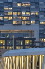 The lights of the Imhoff Chocolate Museum, behind them the illuminated façade of Kranhaus Nord,
