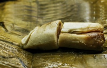 Close up of a traditional tamale on a banana leaf. Nicaraguan pisque tamale on banana leaf.