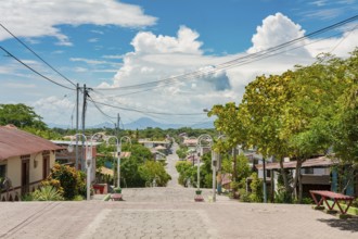 Streets of Nagarote with a view of the momotombo volcano on a suny day. View of the streets of