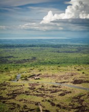 Aerial view of an asphalt road in a rural location. Landscape of a rural road surrounded by