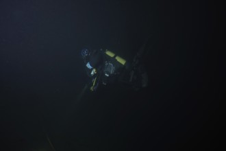Divers at night in Lake Walen. Tauchplatz Känzeli, Mols, Canton of St. Gallen, Switzerland