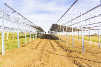 Metal frameworks for solar panels in a field under a blue sky, Energiewende, construction of PV