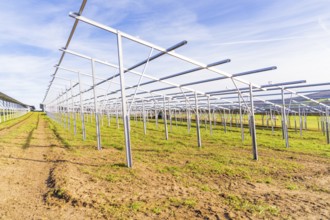 Metal framework on a field under a blue sky for solar systems, energy revolution, construction of