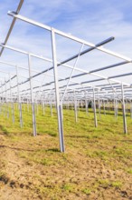 Empty metal frames on a field under a blue sky, Energiewende, construction of PV open space,