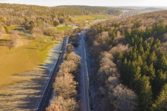 Aerial view of a railway line between trees and a road in a rural area, construction of the Hermann
