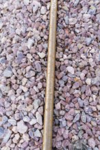 Close-up of gravel and a metal bar in a detailed view of the tracks, construction of the Hermann