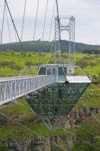 Bridge with glass structure over a green landscape and hills, diamond bridge, Diamond Glass Bridge,
