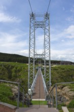 View of a high suspension bridge with steel girders against the blue sky, Diamond Bridge, Diamond
