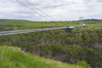 Long glass bridge spanning green landscape and gorge, diamond bridge, Diamond Glass Bridge, world's
