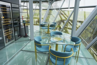 A modern café with glass floors and blue chairs offers impressive views, Diamond Bridge, Diamond