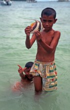 Two boys with a tropical fish on Ko Phi Phi Don, two years in front of the tsunami, Thailand,