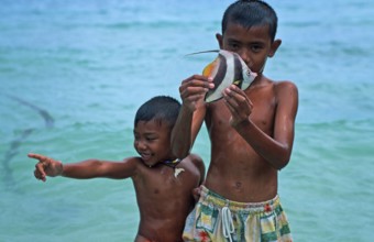 Two boys with a tropical fish on Ko Phi Phi Don, two years in front of the tsunami, Thailand,