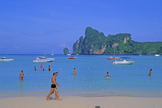 People, boats on the beach of Ko Phi Phi Don, two years in front of the tsunami, Thailand, December