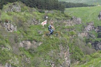 Adventurous bicycle ride on a rope through a distinctive rocky landscape, Dashbashi Gorge, Khrami