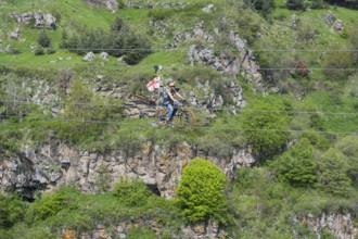 A bicycle ride on a rope leads across a rocky, green gorge, Dashbashi Gorge, Khrami River, Tsalka