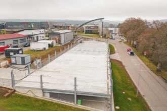 Aerial view of a large parking area in an industrial park, autumnal atmosphere, parking garage