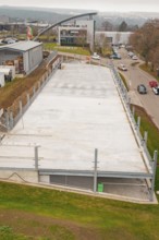 Today's view of an empty parking lot in an urban area, parking garage construction with charging