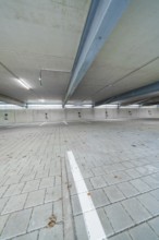 Empty interior of a parking garage with concrete walls and ceiling, parking garage construction