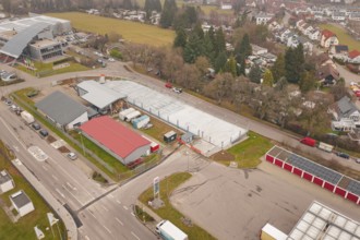 Urban environment seen from above with parking lots and roads in winter, parking garage
