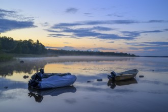 Two boats on a calm lake at sunset, Torne, Asnen National Park, Kronoberg, Sweden