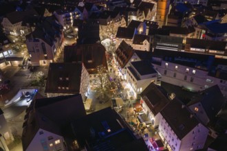 Illuminated streets and buildings of a city in a nocturnal, wintery atmosphere, Weihnachtsmark