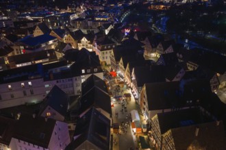 Aerial view of an atmospheric city at night with illuminated streets and houses, Weihnachtsmark