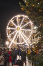 Lights of a Ferris wheel structure in the midst of a crowd at a Christmas market, Weihnachtsmark