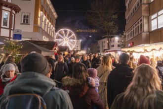 Busy night market with glowing Ferris wheel and crowd, Weihnachtsmark Nagold, LandkreiScalw,