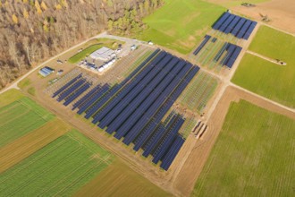 Extensive solar system surrounded by green fields, surrounded by autumn trees, energy revolution,