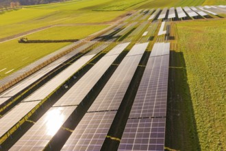 Rows of solar panels on agricultural fields under sunny skies, Energiewende, construction of PV
