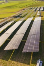 Close-up of solar cells on green fields under bright sky, Energiewende, construction of PV open