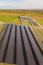 Rows of solar systems on green fields under clear skies, Energiewende, construction of PV open