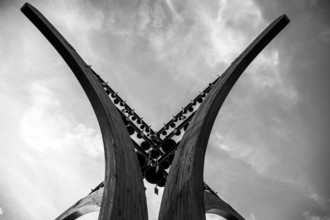 Abstract wooden sculpture against a dramatic black and white sky, Winter War Memorial Winter War