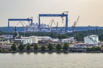 Industrial harbor scene with cranes and shipyards on the water, Meyer Werft, Turku, Finland