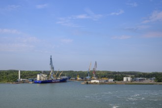 Coastal landscape with harbor and commercial ships under blue sky, Turku, Finland