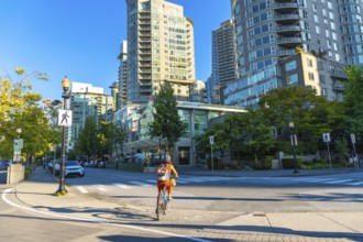 Cyclist enjoying a sunny day, riding a bicycle on a dedicated bike lane in the city center of