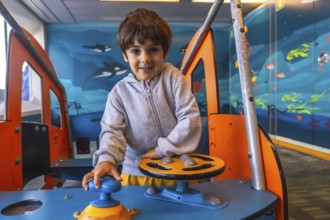 Young boy enjoying playing captain on a ferry boat traveling from victoria, vancouver island, to