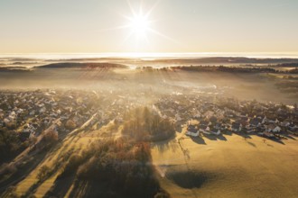 Landscape with settlement in warm light of sunrise and fog, Gechingen, Calw district, Germany