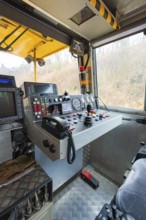 Interior view of a cockpit with control panel in a track construction vehicle, tamping machine on