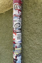 Downpipe covered with stickers, advertising, event information, façade, local storks, Tübingen,