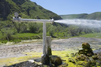 Natural water source with sparkling water jet against green mountain landscape, Vardzia, Vardzia,